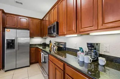 a kitchen with wooden cabinets and stainless steel appliances at 4816 Cayview Avenue 407 in Orlando