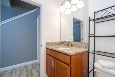 a bathroom with a sink and a mirror at 4812 BR - Enchanted Lakeside Escape Luxurious Family Retreat in Kissimmee