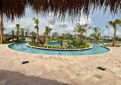 a swimming pool with a fountain in a resort at Stunning Townhome with Private Pool - Storey Lake - 5021 WW in Kissimmee