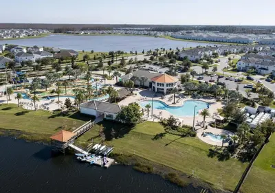 an aerial view of a resort on the water at Stunning Townhome with Private Pool - Storey Lake - 5021 WW in Kissimmee