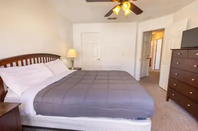 a bedroom with a large bed and a dresser at 4562 YR Amazing in Kissimmee