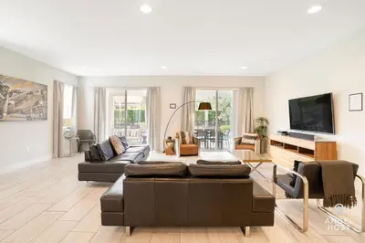 a living room with a couch and a tv at Palatial 9BR Private Pool Villa Theater Game Room in Orlando