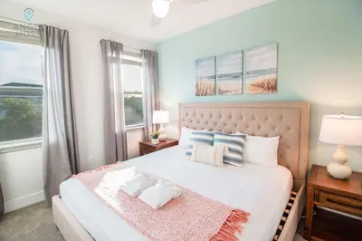 a bedroom with a bed with two pillows on it at Palatial 9BR Private Pool Villa Theater Game Room in Orlando