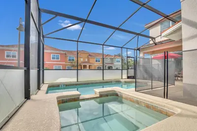 an indoor swimming pool with a large glass wall at 9008 Paradise Palms Blissful Haven 5-Bed Oasis of Luxury and Tranquility in Orlando