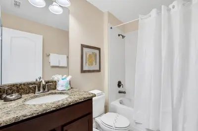 a bathroom with a sink and a toilet and a shower at 9008 Paradise Palms Blissful Haven 5-Bed Oasis of Luxury and Tranquility in Orlando
