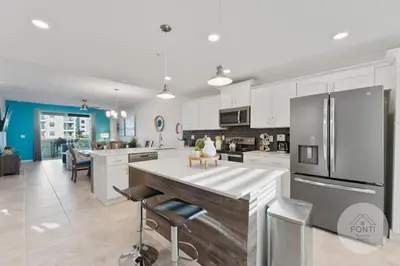 a kitchen with white cabinets and a large white counter top at Modern Storey Lake Resort Disney Orlando 3120-105 in Kissimmee