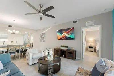 a living room with a blue couch and a table at Modern Storey Lake Resort Disney Orlando 3120-105 in Kissimmee