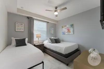 a bedroom with two beds and a ceiling fan at Modern Storey Lake Resort Disney Orlando 3120-105 in Kissimmee