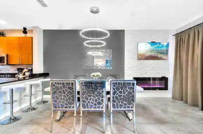 a kitchen with a table and chairs in a room at Resort Home near Disney Themed Jacuzzi Pool 2609 in Orlando