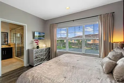 a bedroom with a large bed and a large window at Resort Home by Disney Themed Jacuzzi Pool 2666 in Orlando