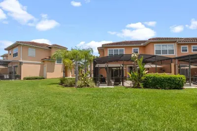 a house with a green lawn in front of it at Resort Home by Disney Themed Jacuzzi Pool 2666 in Orlando