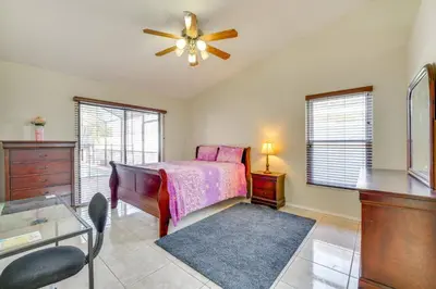 a bedroom with a bed and a ceiling fan at Furnished Lanai and Lake View Quiet Home in Orlando in Kissimmee