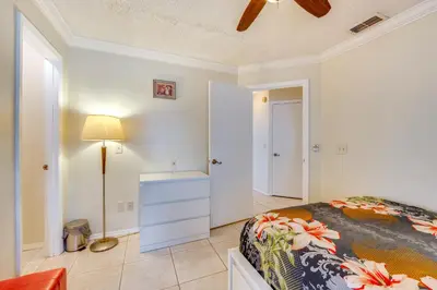 a bedroom with a bed and a dresser and a lamp at Furnished Lanai and Lake View Quiet Home in Orlando in Kissimmee