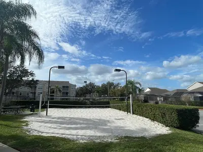 a tennis court with snow on the grass and street lights at Beautiful Apartment Near Disney in Kissimmee