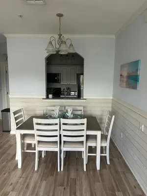 a dining room with a white table and chairs at Beautiful Apartment Near Disney in Kissimmee