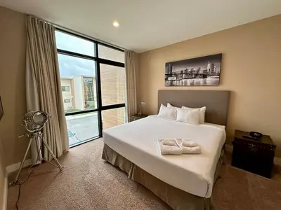 a bedroom with a bed and a large window at Luxury Home 7 Min Disney Universal 3BR4BA - Hot Tub in Orlando
