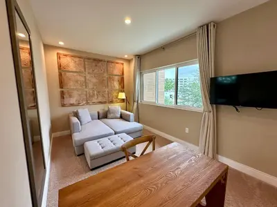a living room with a couch and a table at Luxury Home 7 Min Disney Universal 3BR4BA - Hot Tub in Orlando