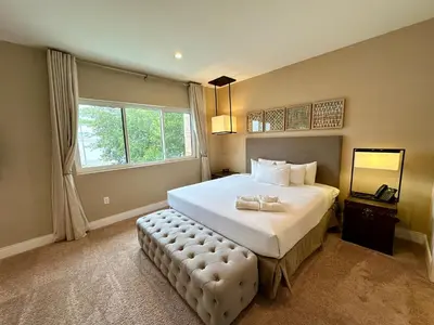 a bedroom with a large bed with a large window at Luxury Home 7 Min Disney Universal 3BR4BA - Hot Tub in Orlando