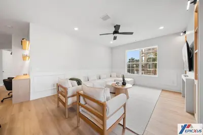 a living room with a white couch and a table at The epic Orlando Vista Cay in Orlando