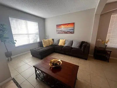 a living room with a couch and a coffee table at Charming Family Friendly Home in Kissimmee