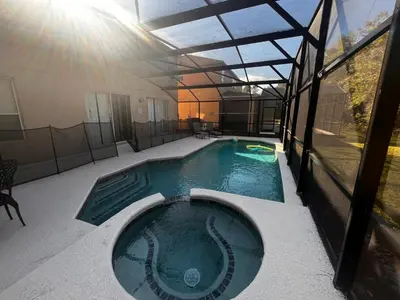 a swimming pool in the middle of a building at Charming Family Friendly Home in Kissimmee