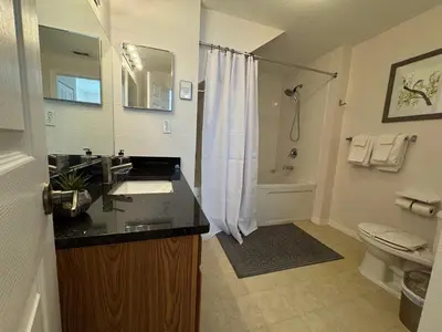 a bathroom with a sink and a toilet and a shower at 4 Bedroom 3 Bathroom Villas At SevenDwarfs 31-107 in Kissimmee