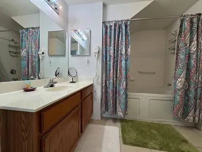 a bathroom with a sink and a shower and a tub at 4 Bedroom 3 Bathroom Villas At SevenDwarfs 28-107 in Kissimmee