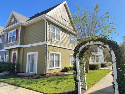 an archway in front of a house at 4 Bedroom 3 Bathroom Villas At SevenDwarfs 28-107 in Kissimmee