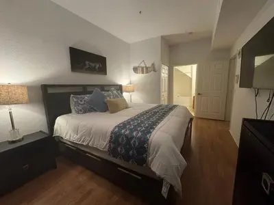 a bedroom with a large bed and a television at 4 Bedroom 3 Bathroom Villas At SevenDwarfs 22-108 in Kissimmee