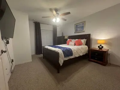 a bedroom with a bed and a ceiling fan at 4 Bedroom 3 Bathroom Villas At SevenDwarfs 22-108 in Kissimmee