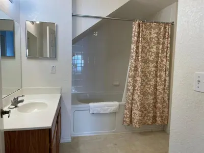 a bathroom with a shower curtain and a sink at 3 Bedroom 2 Bathroom Villas At SevenDwarfs 19-106 in Kissimmee