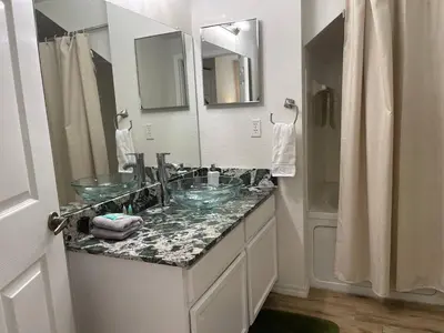 a bathroom with two glass sinks and a shower at 3 Bedroom 2 Bathroom Villas At SevenDwarfs 15-103 in Kissimmee