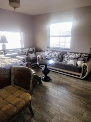 a living room with a couch and a table at A peaceful living vibe in Orlando