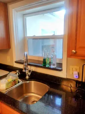 a kitchen sink with a window in a kitchen at A peaceful living vibe in Orlando