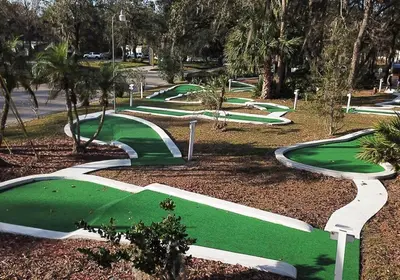a row of green golf courses in a park at Your home away from home! Entire cottage- Disney in Kissimmee