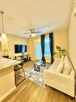 a living room with a couch and a table at Chic 1-Bedroom Apt in Lake Nona in Orlando