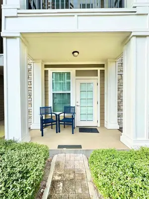a porch with two chairs and a table at Chic 1-Bedroom Apt in Lake Nona in Orlando