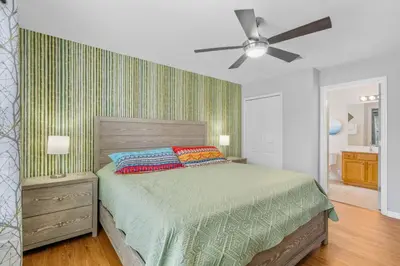 a bedroom with a bed and a ceiling fan at La Isla Retreat - amazing 6 bedroom pool house near Disney Parks in Kissimmee