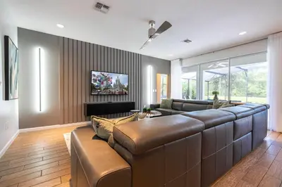 a living room with a large couch and a tv at Luxury Lakeview Home Private Pool 2687 in Kissimmee