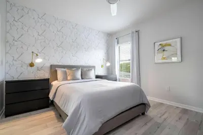 a white bedroom with a large bed and a window at Luxury Lakeview Home Private Pool 2687 in Kissimmee