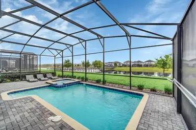 an image of a swimming pool with a pergola at Lakefront Luxury Retreat Private Pool & Movie Theater 367 in Kissimmee