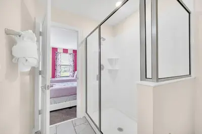 a bathroom with a shower with a glass door at Lakefront Luxury Retreat Private Pool & Movie Theater 367 in Kissimmee
