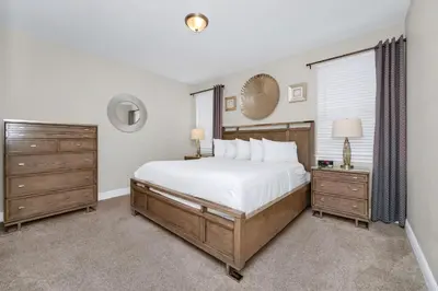 a bedroom with a large bed and a window at Spacious Home With Private Pool, Themed And Game Room Near Disney With Waterpark & Resort Access - 341Pn in Kissimmee