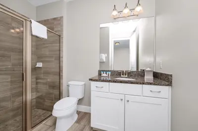 a bathroom with a toilet and a sink and a shower at Spacious Home With Private Pool, Themed And Game Room Near Disney With Waterpark & Resort Access - 341Pn in Kissimmee