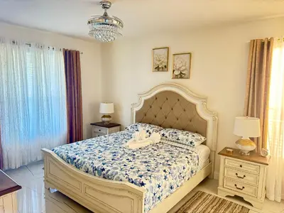 a bedroom with a bed and two night stands and two lamps at Bloomslake Resort in Kissimmee