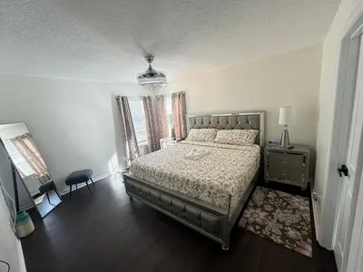 a bedroom with a bed and a dresser and windows at Bloomslake Resort in Kissimmee