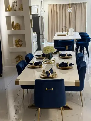 a kitchen with blue chairs and a table with food on it at Bloomslake Resort in Kissimmee