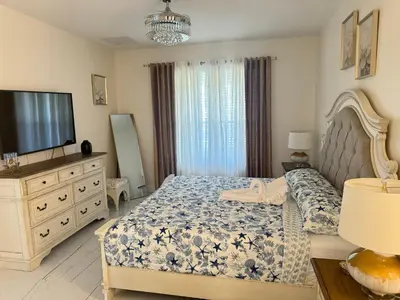 a bedroom with a bed and a tv and a dresser at Bloomslake Resort in Kissimmee