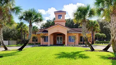 a house with a clock tower on top of a yard at Modern Guesthouse near MCO in Kissimmee