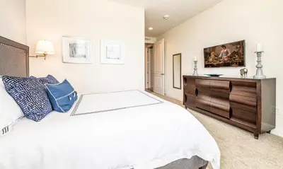 a bedroom with a bed and a dresser at Ultimate 5 Star Villa with Private Pool on Encore Resort at Reunion Orlando Villa 4391 in Orlando